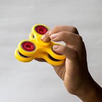 mano de bebé con spinner amarillo. foto