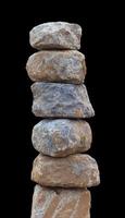 Stones stacked on a concrete pillar. photo