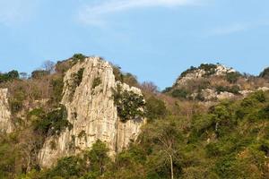 Mountain rock cliff with timber. photo