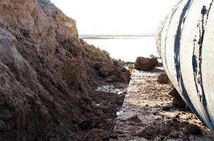 Low angle concrete pipe near the ground under the road. photo