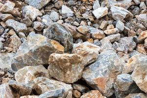 Many large rock pile with soil. photo