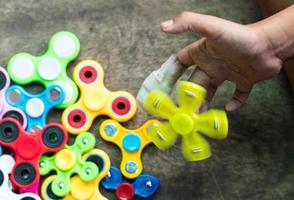 Yellow spinners spin on hands. photo