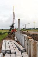 Many concrete pillars with cranes. photo