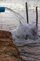 Water outflow pipe in the flood. photo