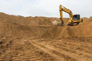 Backhoe on the sand track. photo