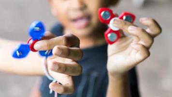 Hand spinner in the hands of boys and girls. photo