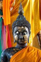 Black Buddha with golden fabric.
