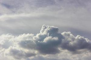 Fluffy clouds backlit scenery. photo