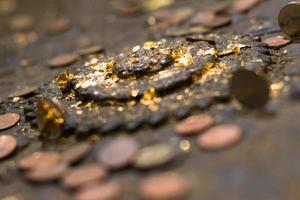 Many old coins on the ancient altar. photo