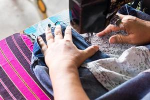 Repair jeans with an old sewing machine. photo