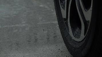 Rain splashing and car tire in rainwater. Car parking in the rain. video