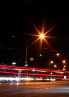 Car headlights and night street lamps. photo