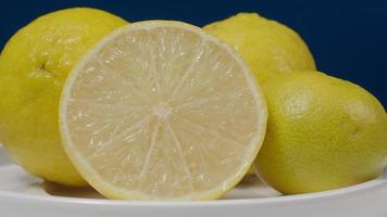 Delicious lemon moving on turntable isolate on the black background. video