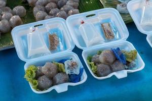 Steamed sago and dumplings in a foam box. photo