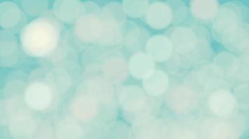 Abstract white bokeh texture on pastel blue background video