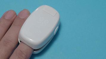 Oximeter usage. Finger pulse oximeter used to measure pulse rate and oxygen levels.