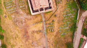 Aerial top down circular view tourists by Odzun church landmark with village houses panorama . Famous Armenian basilica constructed V - VII century in Lori province video