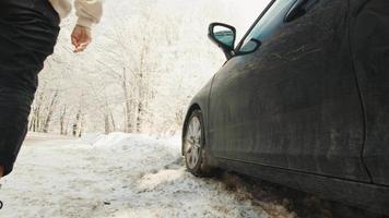 Close up slow motion young woman open black car door in forest.Leisure adventure activities winter nature. video