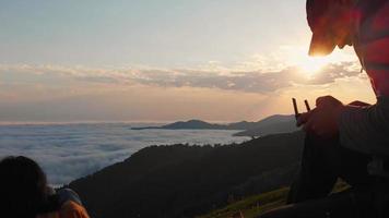 Static view of male caucasian person holding drone controller with scenic sunrise in background video