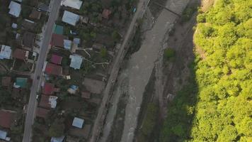 Aerial view down to river and traditional georgian houses in Pasanauri village. Georgian culture and lifestyle concept video