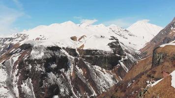 Static scenic caucasus mountains nature panning view with snowy peaks and blue sky in spring. video