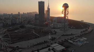 Revealing aerial panoramic view of Batumi city architecture and unique buildings with stunning sunset background video