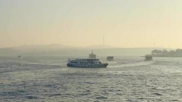 Static view of boats moving around golden horn canal in the morning with big city pollution haze in air video