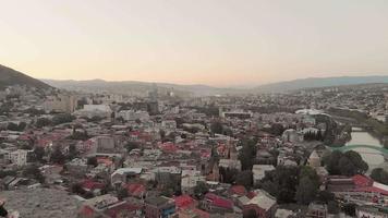 Revealing view of female person on Narikala castle ruins wall look to scenic evening panorama of Tbilisi video