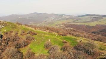 Young female hiker outdoors hiking on trail with scenic nature caucasus panorama.