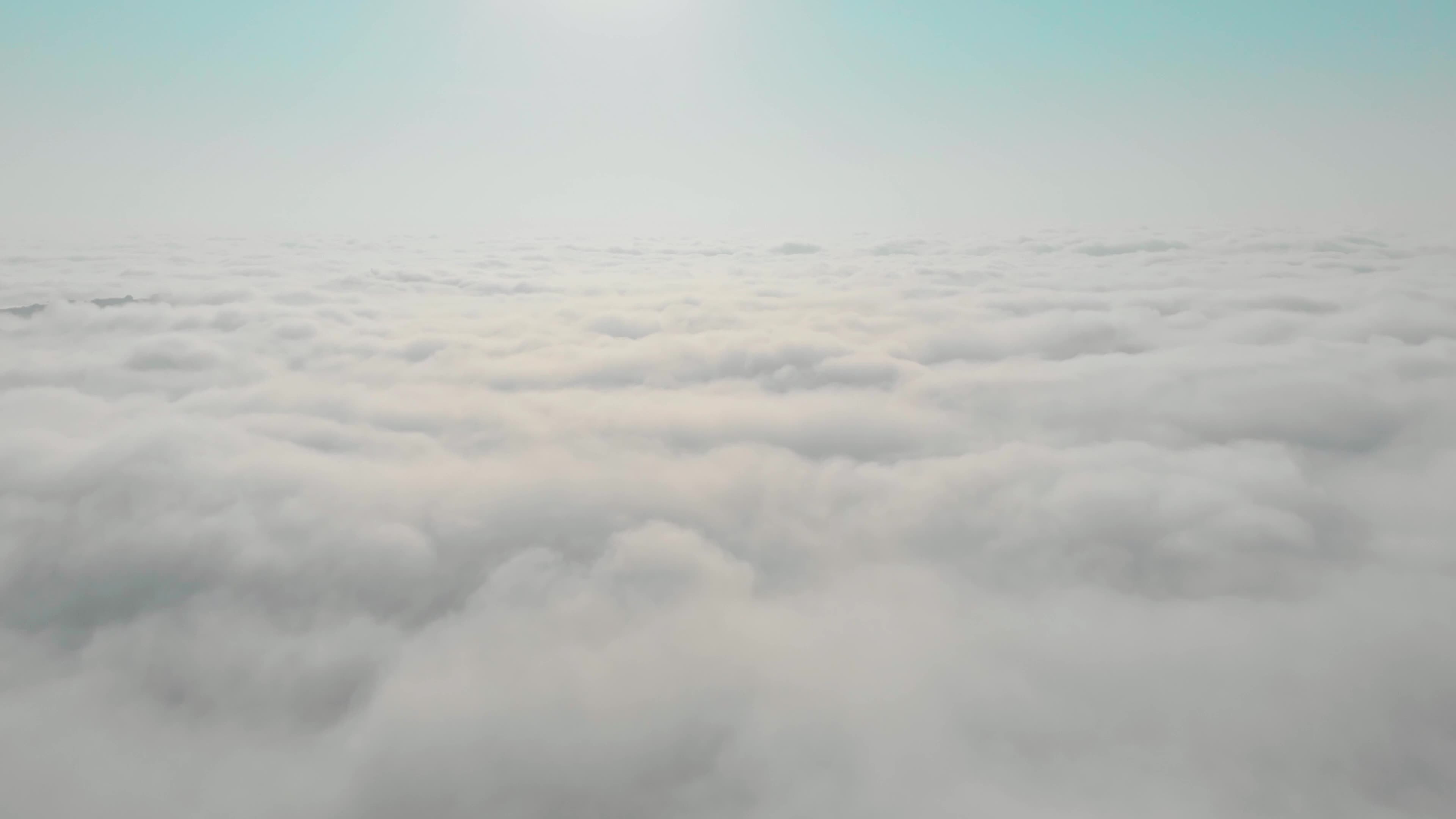 Tilt up view zoom in view above white clouds and sky. Dreamy background