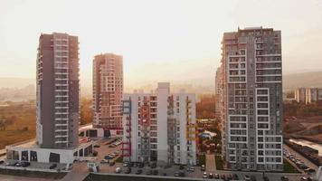 Tbilisi, Georgia, 2021 - Green diamond apartments complex buildings panorama with sunny sunset background. Georgia real estate property business industry concept video