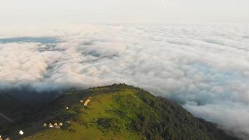 Aerial flyover above new wooden house construction site in scenic Gomismta location above clouds. Georgia tourism and real estate development video