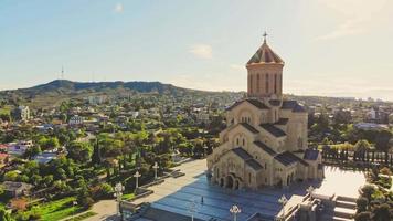 Aerial side view of Holy trinity cathedral in capital city Tbilisi. Third tallest eastern orthodox cathedral in world. Architecture of churches in caucasus concept video