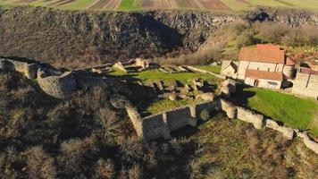 Descending aerial view famous Dmanisi archeological site ruins landmark with valley background in autumn video