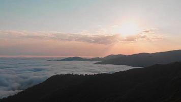 Aerial panoramic view of sun rising above horizon with clouds above forest. Weather and forecast background video