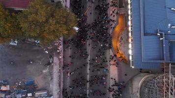 Tbilisi, Georgia, 28th october, 2021- Aerial tilt up view crowds of dreamers supporters walk in streets on demonstration on democratic party Georgian dream political agitation event video
