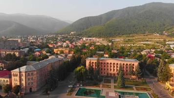 Aerial zoom in view Vanadzor city hall with city buildings panorama in Armenia