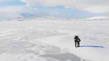 Slow motion static view mother and kid pose for selfie with white winter landscape video