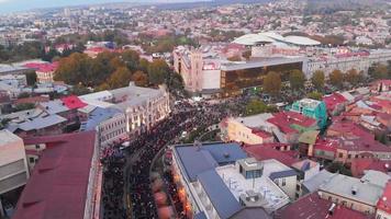Tbilisi, Georgia - 28th october, 2021 - Aerial static view crowds of dreamer supporters walk in streets on demonstration on democratic party Georgian dream political agitation event video