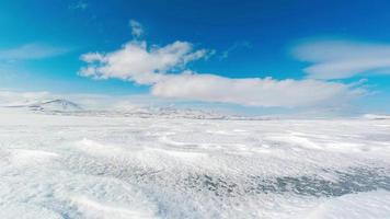 Tranquil winter landscape timelapse with blue sky and white mountains landscape. Frozen lake in winter concept video