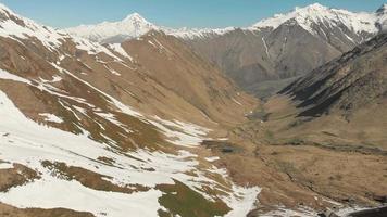 voo aéreo sobre o terreno do vale de juta com panorama deslumbrante das montanhas do parque nacional de kazbegi. Geórgia video