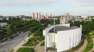 Beautiful and modern Siauliai church in southern part of the city from aerial perspective. City buildings on the background.