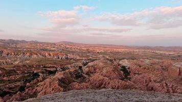 4k stock video timelapse of cloudy sky over volcanic mountains in Cappadocia, Anatolia, Goreme in Turkey country. Hiking destination - Rose valley. Aerial view at cloudscape panorama over horizon