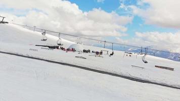 Side aerial view ski lifts in Gudauri ski resort in sunny beautiful day.