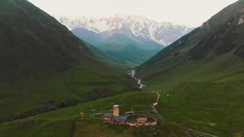 Stunning birds eye view of Lamaria monastery in Ushguli with beautiful mountains view panorama video