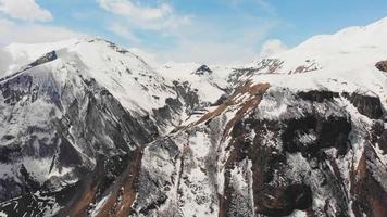 Static aerial view scenic caucasus mountains panorama with bird crossing in sunny spring day