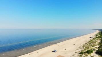 Rising aerial view Palanga holiday resort. Lithuania beach holiday vacation by blue baltic sea in sunny weather video