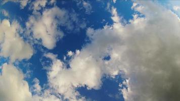 View up from below to cloudscape timelapse. Beauty of color and light in summer. Abstract nature background fluffy, puffy cloudscape in air. High relaxing sunny cumulus in slow motion video