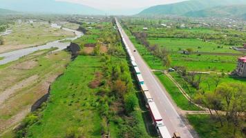 statische luftansicht lange schlangen von lastwagen stecken entlang der georgien-russischen autobahn in georgien, kaukasus. video