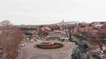Close up rising view statue of King Vakhtang Gorgasali with panoramic view Tbilisi architecture video